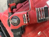 a corded drill that is sitting on top of a red box