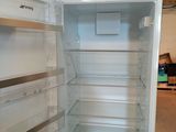 an empty refrigerator with the door open in a room