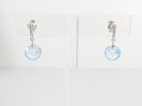 pair of blue crystal earrings on a clear display stand