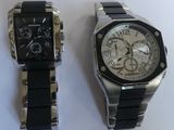 two watches sitting next to each other on a table