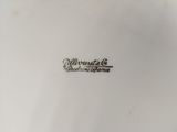 a close up of a white plate with a black writing on it