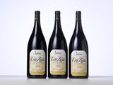 three bottles of wine sitting on top of a table next to each other