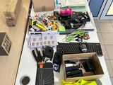 a desk with a computer, keyboard, mouse, and other office supplies on it
