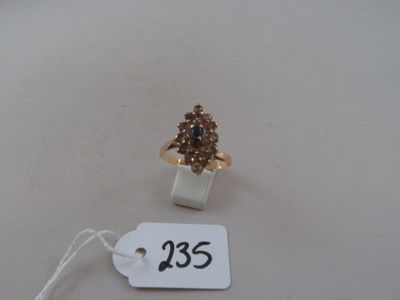 a gold ring with a brown stone on it
