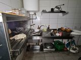 a kitchen with a stove, sink, and other items in it