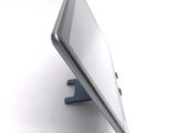 a tablet computer sitting on a stand on a white surface