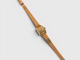 a close up of a gold watch on a white surface