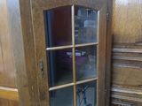 a wooden cabinet with a mirror on top of it