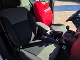 a seat in the back of a truck with a red cover on it