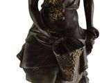 bronze statue of a woman with a basket and a dog