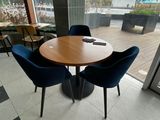 a table with four chairs and a laptop on it
