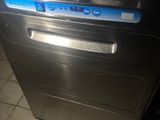 a black dishwasher sitting on a tiled floor in a kitchen