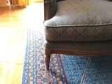 a chair that is sitting on a rug in a room