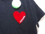 a black t - shirt with a red heart on it