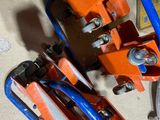 a couple of orange and blue clamps sitting on a table