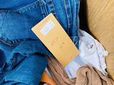 a cardboard box full of clothes and a pair of scissors