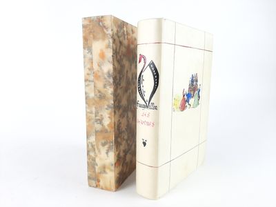 two books sitting next to each other on a white surface