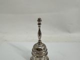 an antique silver plated candle holder on a white surface
