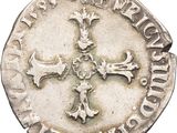 a close up of a coin with a cross on it