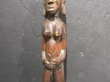 an old wooden statue of a woman holding a baby in her arms