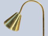 brass table lamp with a cone shaped shade on top of it