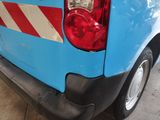 a blue van with red and white stripes parked in a garage