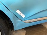 a blue car that has a sticker on the side of it