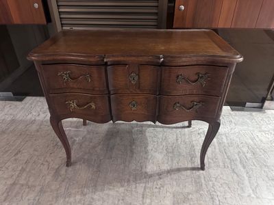 a wooden dresser with drawers on it in a room