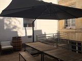 a black umbrella that is on top of a wooden table