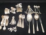 a lot of silver spoons and spoon spoons on a table