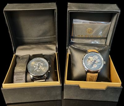 pair of two watches in a box on a black surface