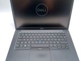 a close up of a dell laptop computer on a white surface