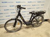 a bicycle that is parked in front of a wall