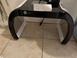 a glass desk with a laptop on top of it