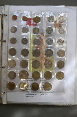 a binder with a bunch of coins in it