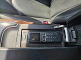 a cell phone sitting in the center of a car