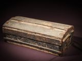 an old wooden box with a metal handle on a purple background