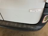 a picture of a white truck with a sticker on it ' s bumper