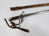 two swords and a cane on a white surface