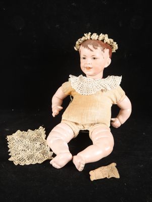 a doll that is sitting on a black surface