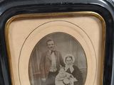 a black and white photo of a man and a woman in a picture frame