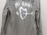 the back of a denim jacket with a heart and arrow drawn on it