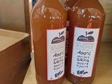 two bottles of apple cid sit on a shelf in a store