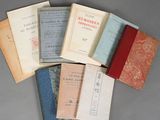 several old books are stacked on top of each other on a table