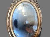 a reflection of a man in a mirror on the wall