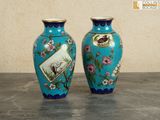 two vases that are sitting on a table