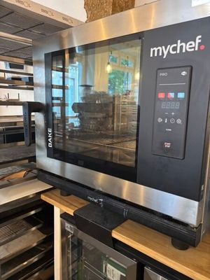a microwave that is sitting on a shelf in a kitchen