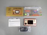 a yellow and red game console sitting on a table