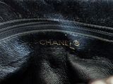 the inside of a black purse with a gold logo on it