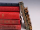 books stacked on top of each other on a white surface
